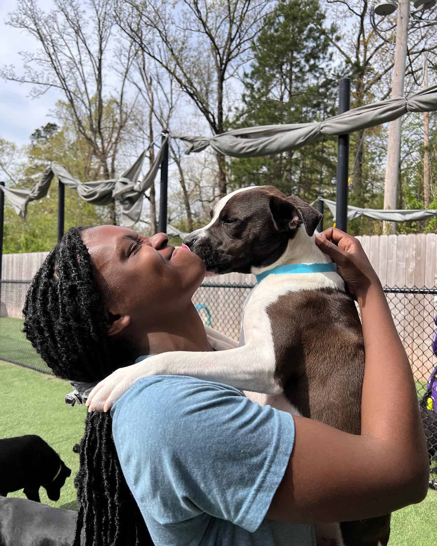 Dog and owner loving each other at a dog park in Arkansas