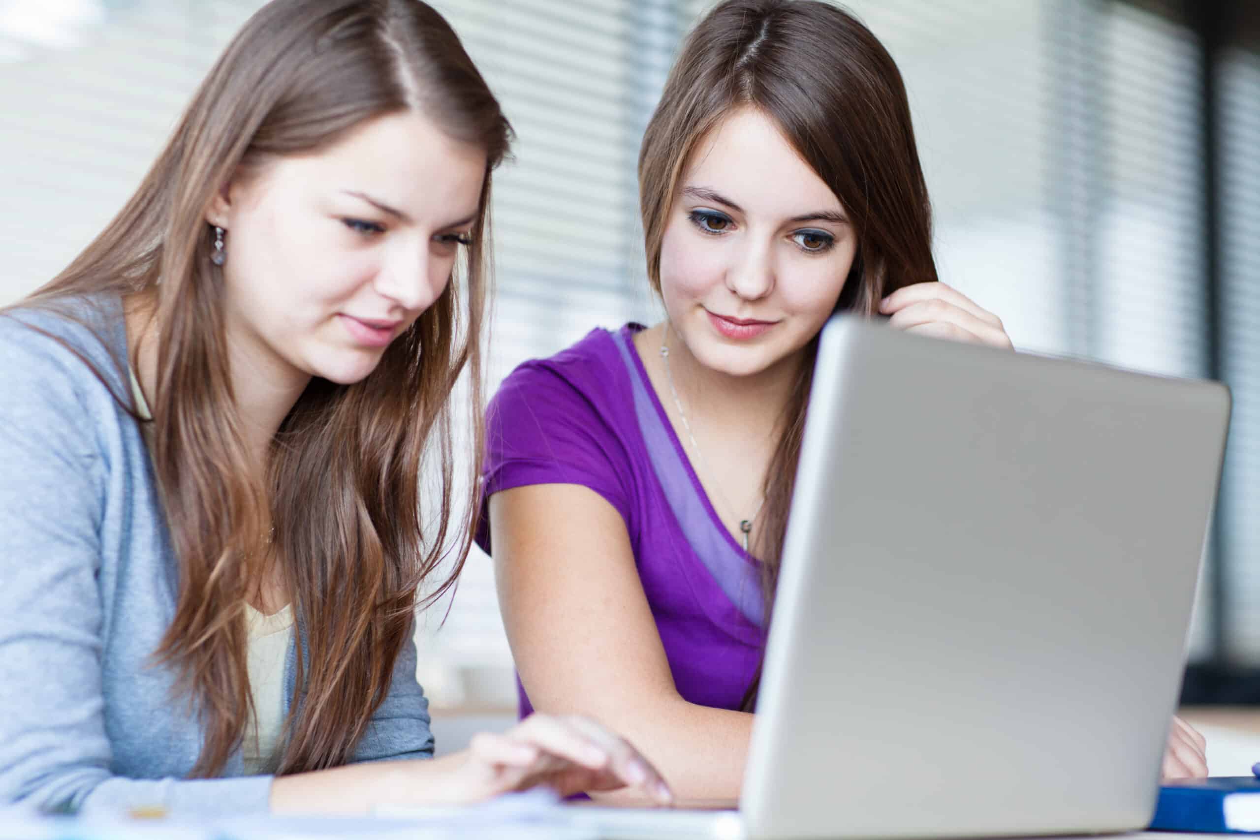 Two,Female,College,Students,Working,On,A,Laptop,Computer,During