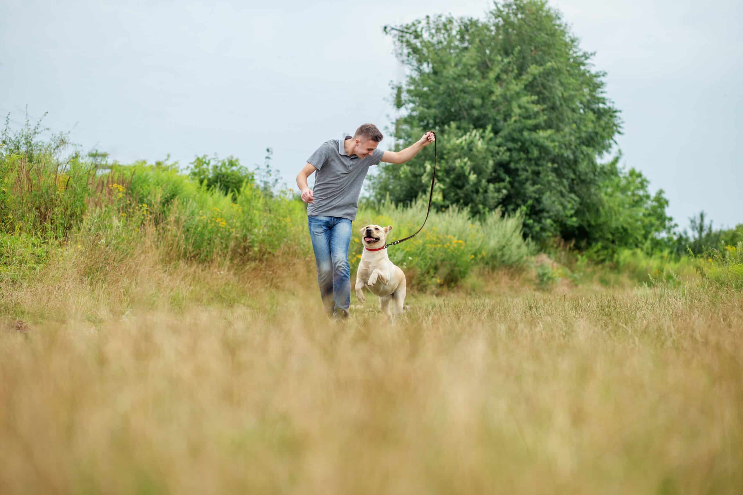 Pet,Concept.,Young,Adult,Man,With,His,Dog,Runs,In