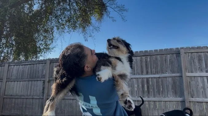 HL staff member holding dog